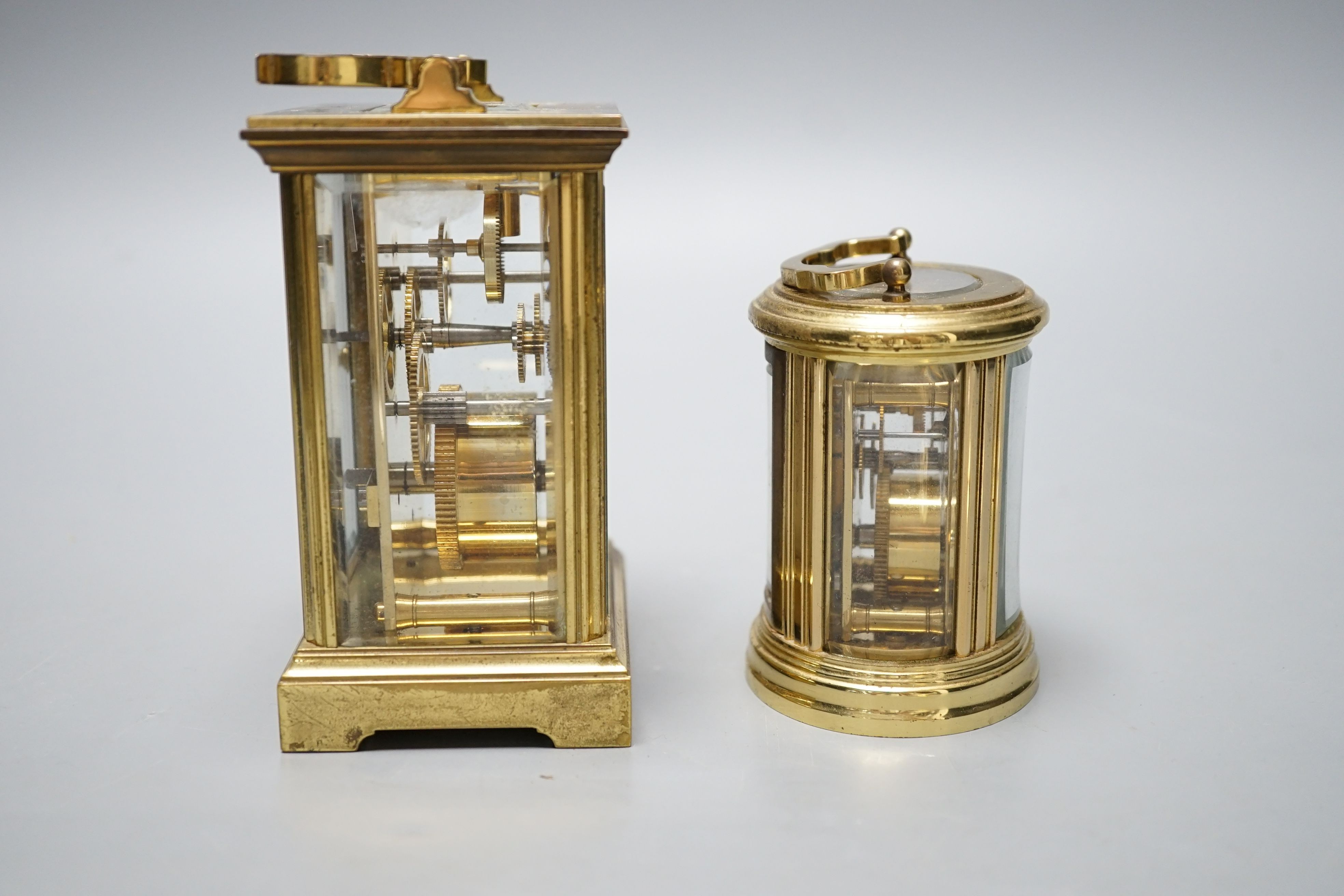 Two modern brass carriage timepieces, one oval cased